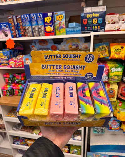 Dense butter-style squishy toy being sliced with a toy knife